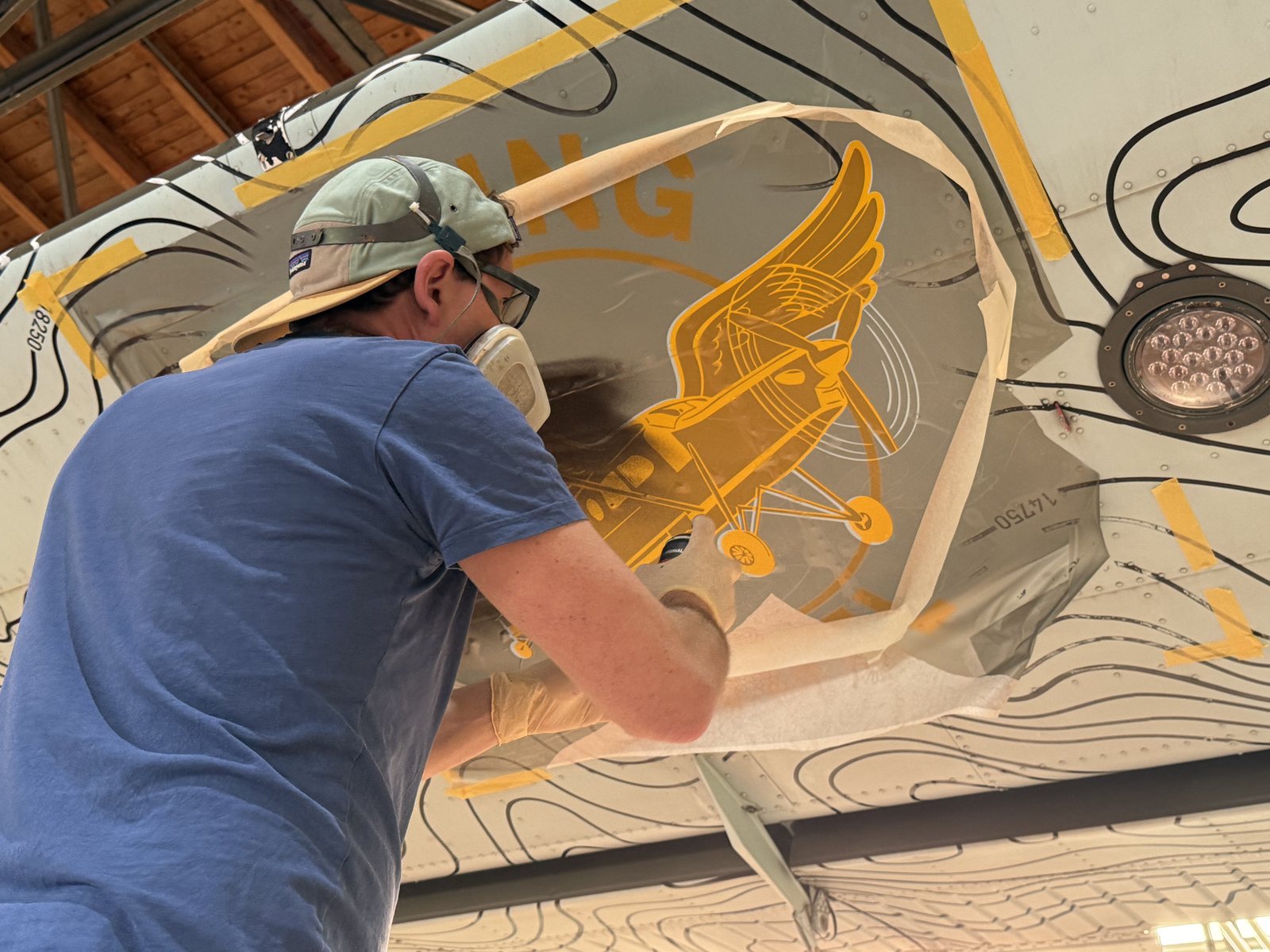 Emanuel Jesse sprüht das Flying-Angel-Logo auf den Rumpf der Porter.